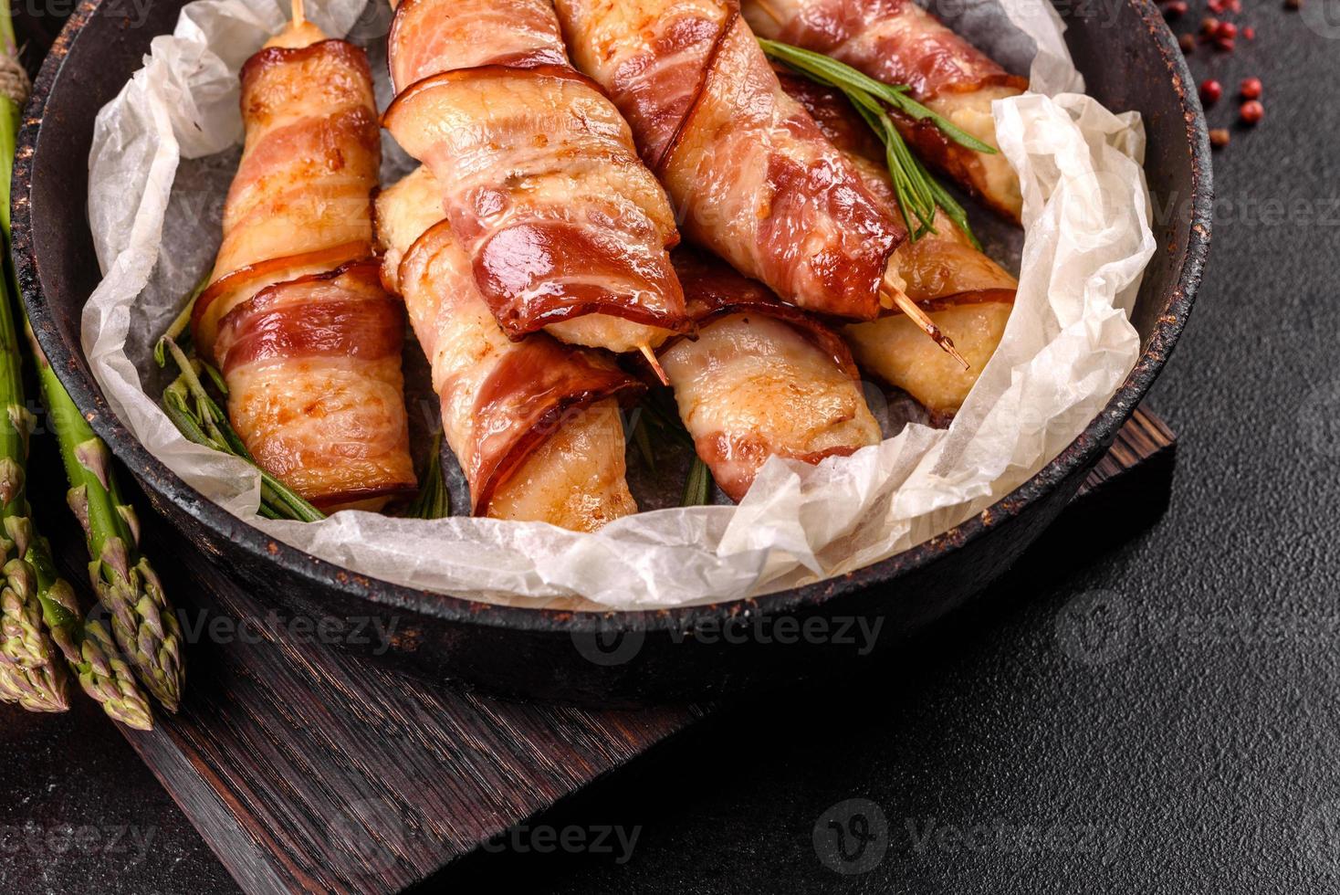 Roll with bacon and chicken mince on a stew with fresh asparagus photo