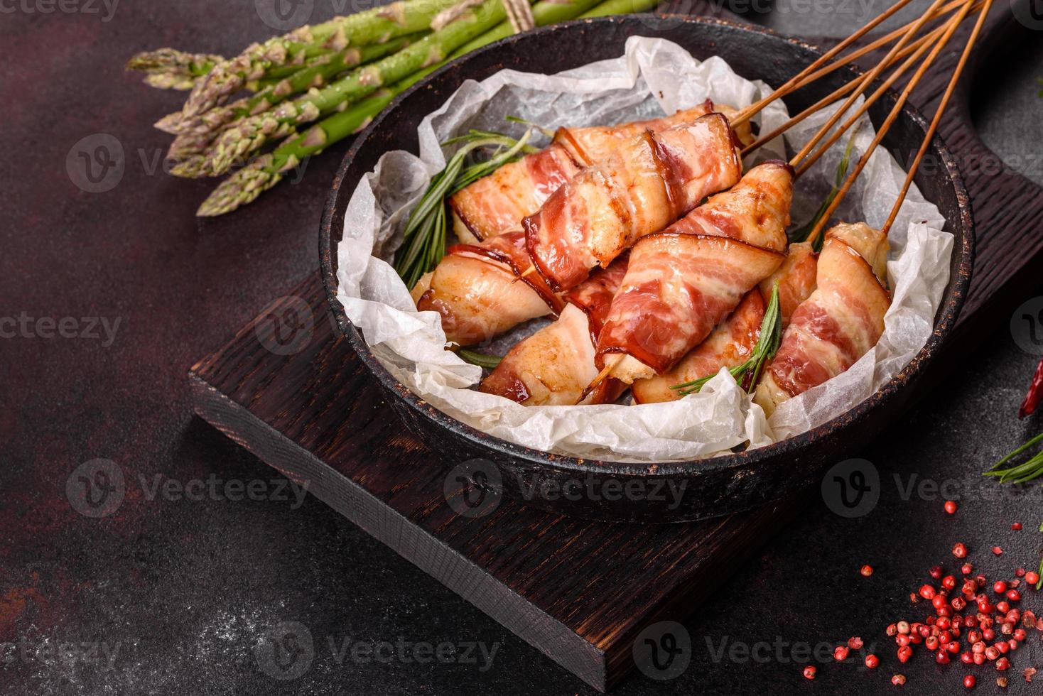 Roll with bacon and chicken mince on a stew with fresh asparagus photo