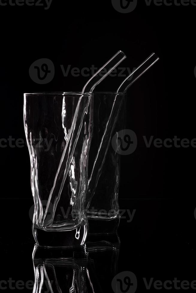 Empty glass silhouette isolated on dark background photo