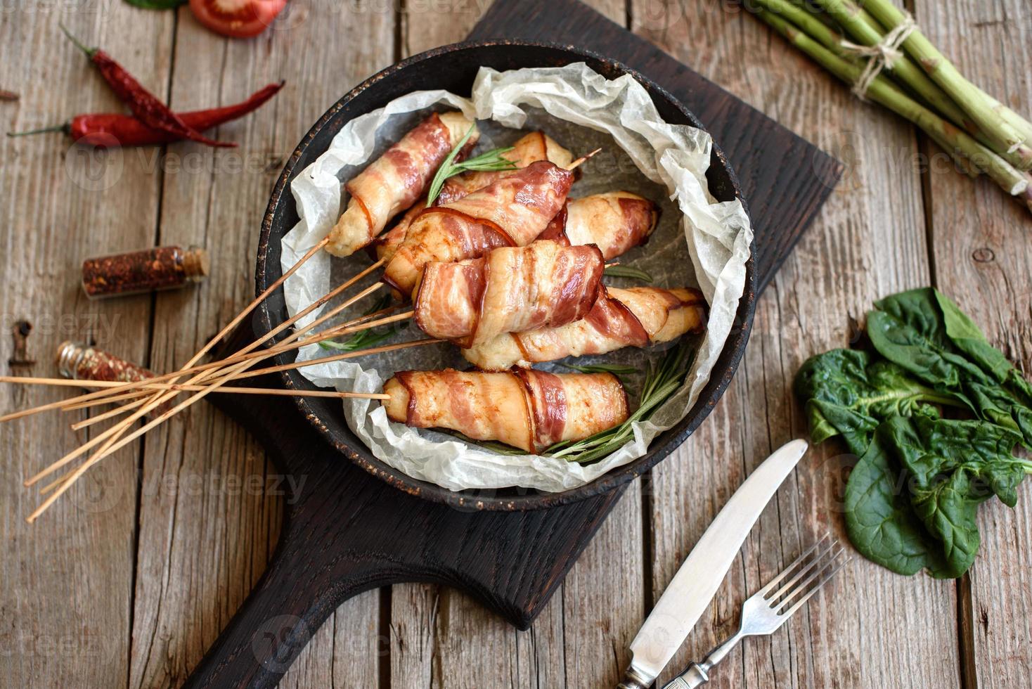 Roll with bacon and chicken mince on a stew with fresh asparagus photo