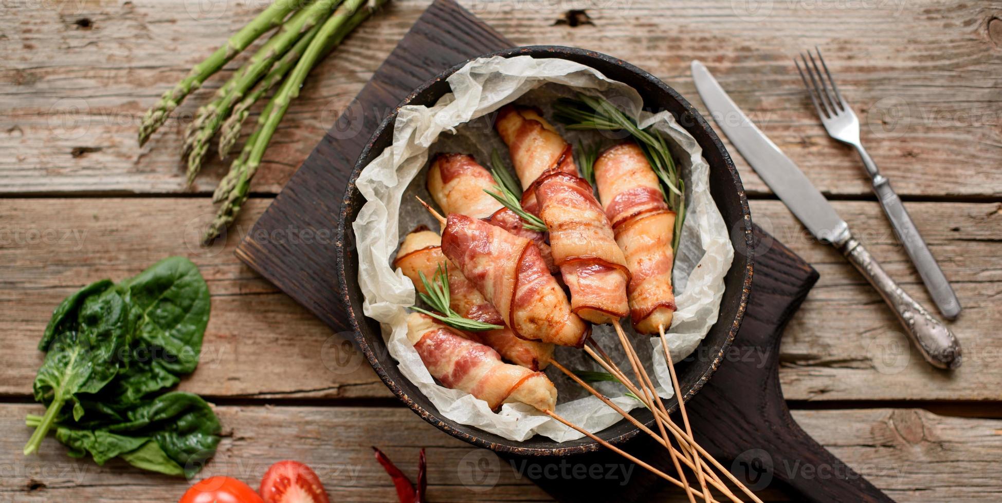 Roll with bacon and chicken mince on a stew with fresh asparagus photo