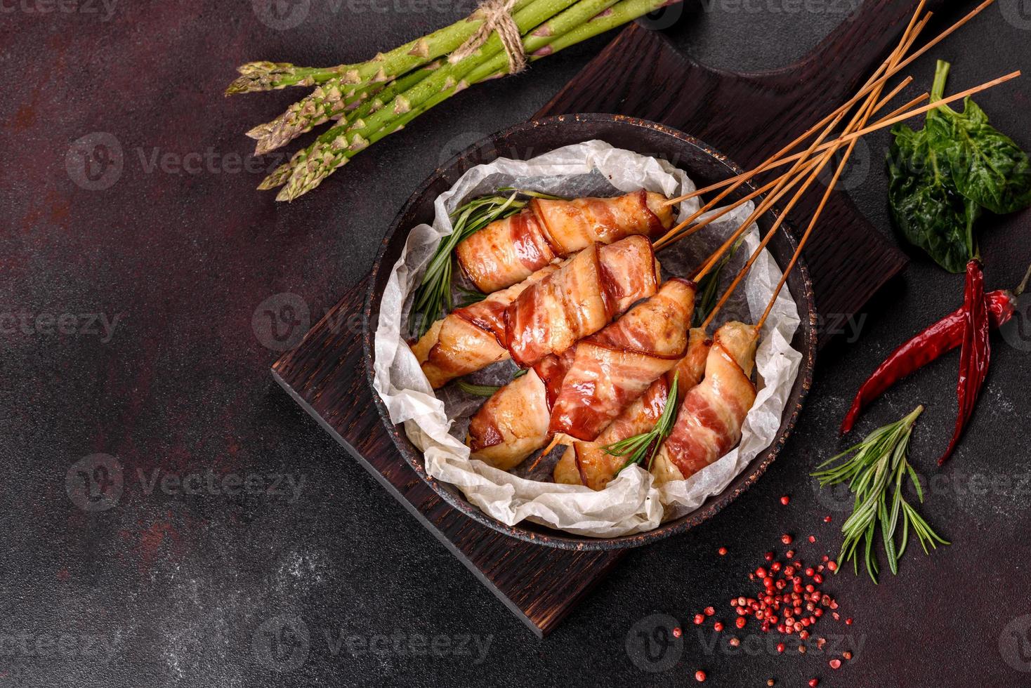 Roll with bacon and chicken mince on a stew with fresh asparagus photo