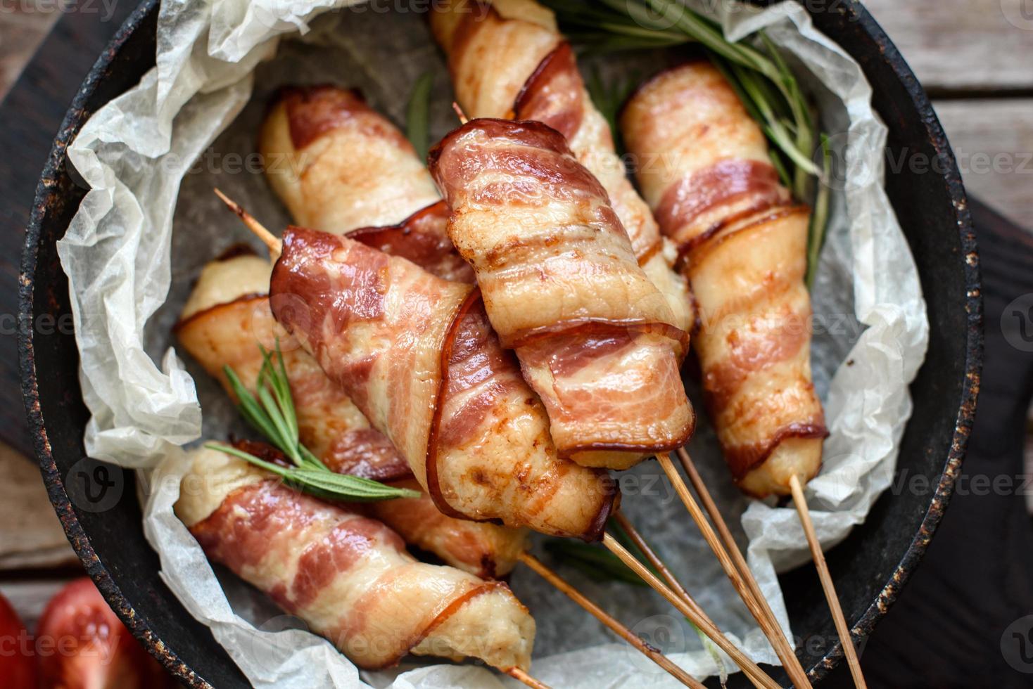 Roll with bacon and chicken mince on a stew with fresh asparagus photo