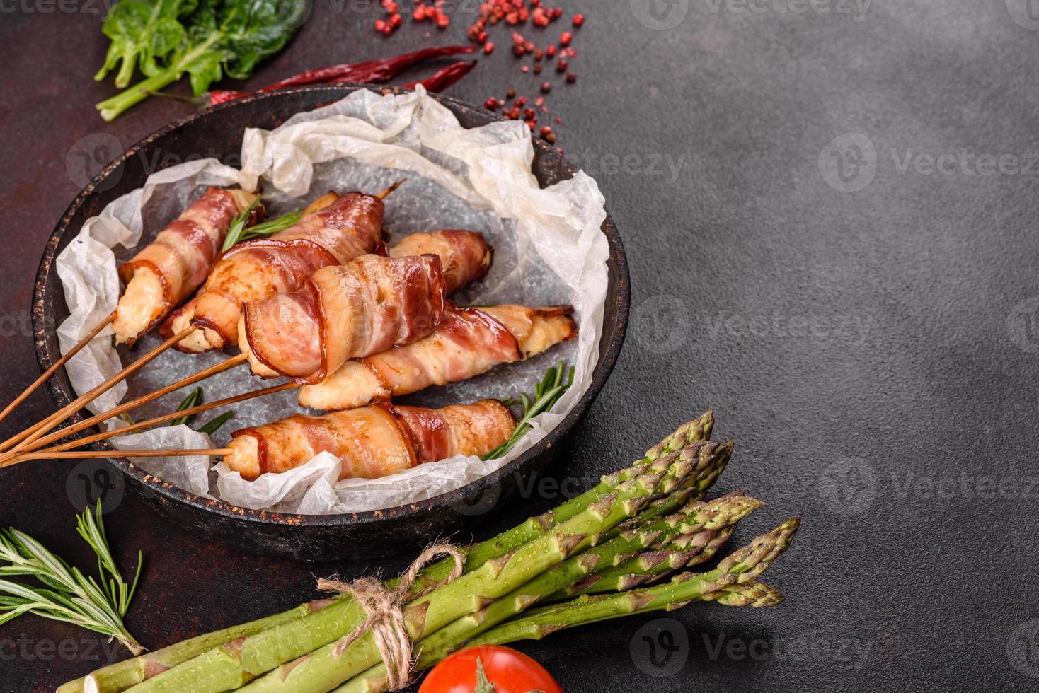 Roll with bacon and chicken mince on a stew with fresh asparagus photo