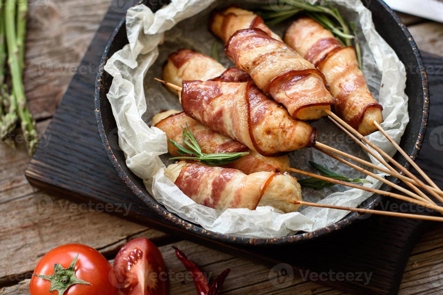 Roll with bacon and chicken mince on a stew with fresh asparagus photo