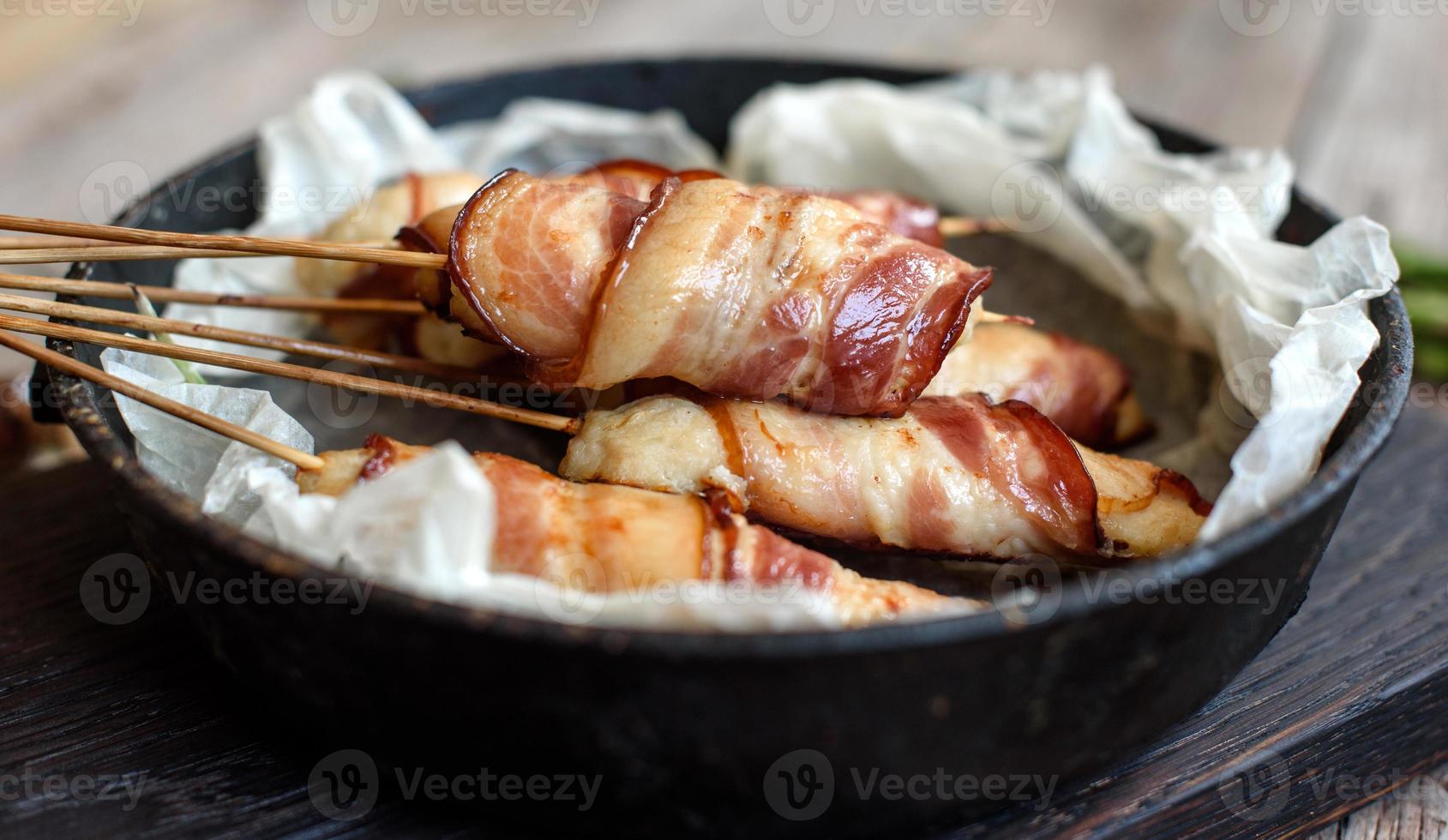 rollito con tocino y pollo picado sobre un guiso con espárragos frescos foto