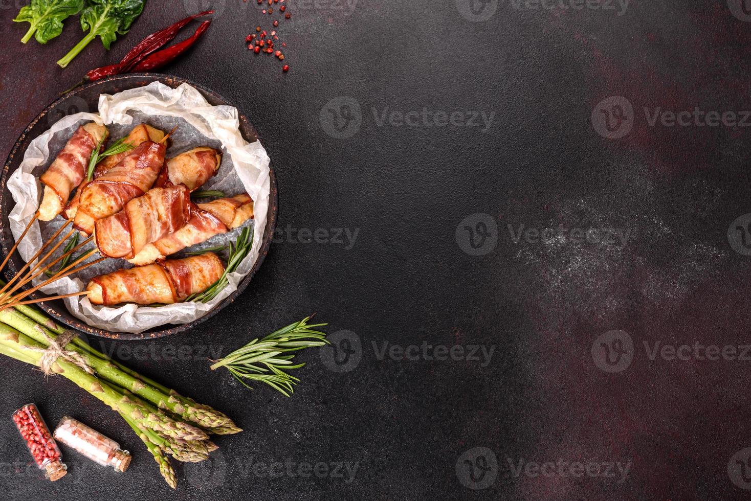 Roll with bacon and chicken mince on a stew with fresh asparagus photo
