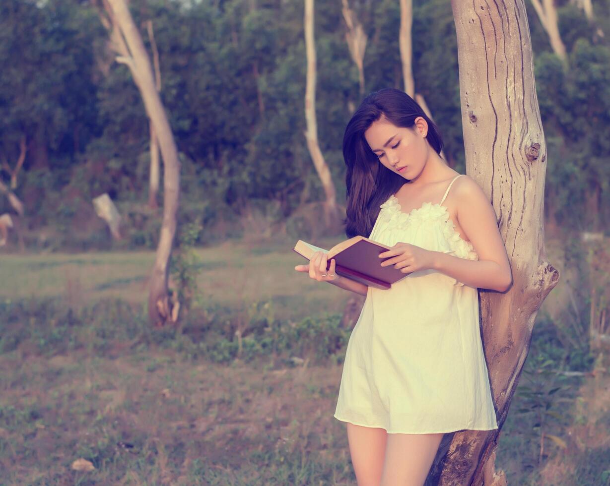 Young girl a reading book with selective focus photo