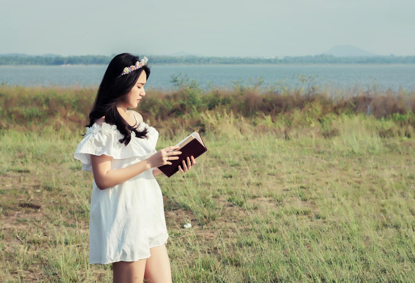 Young girl reading book photo