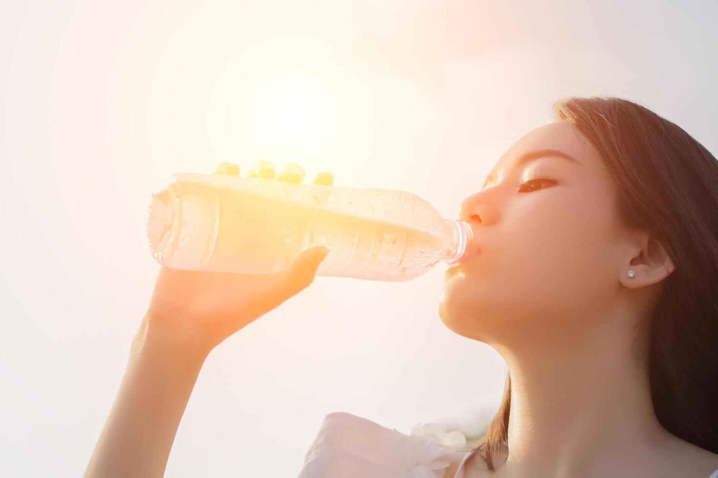 Young woman drinking water look so fresh photo