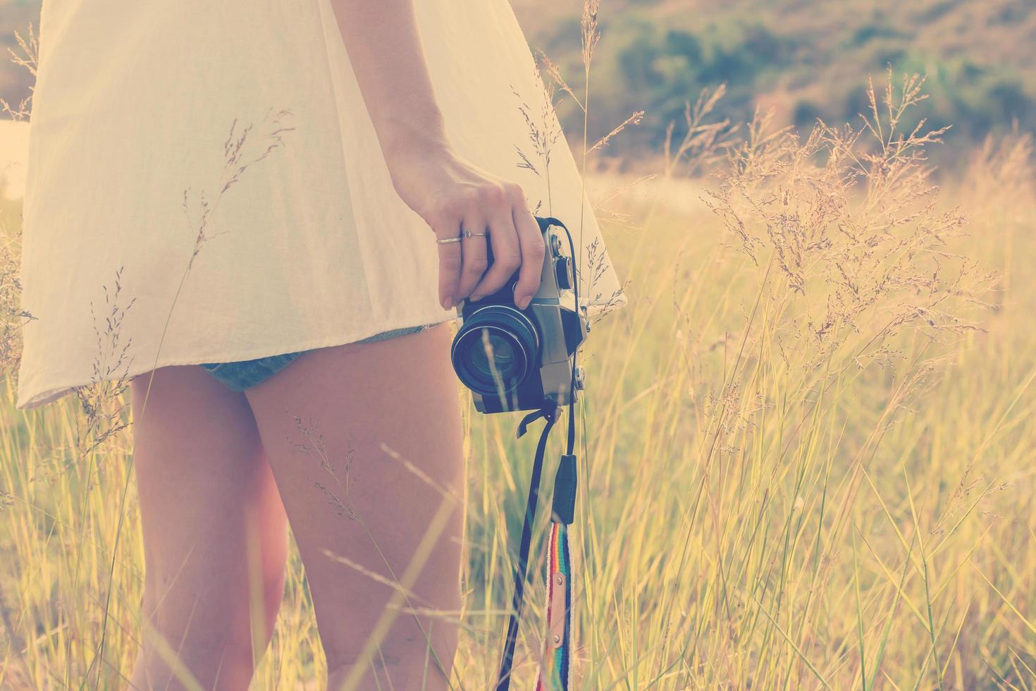 Young woman hand holding retro camera close-up photo