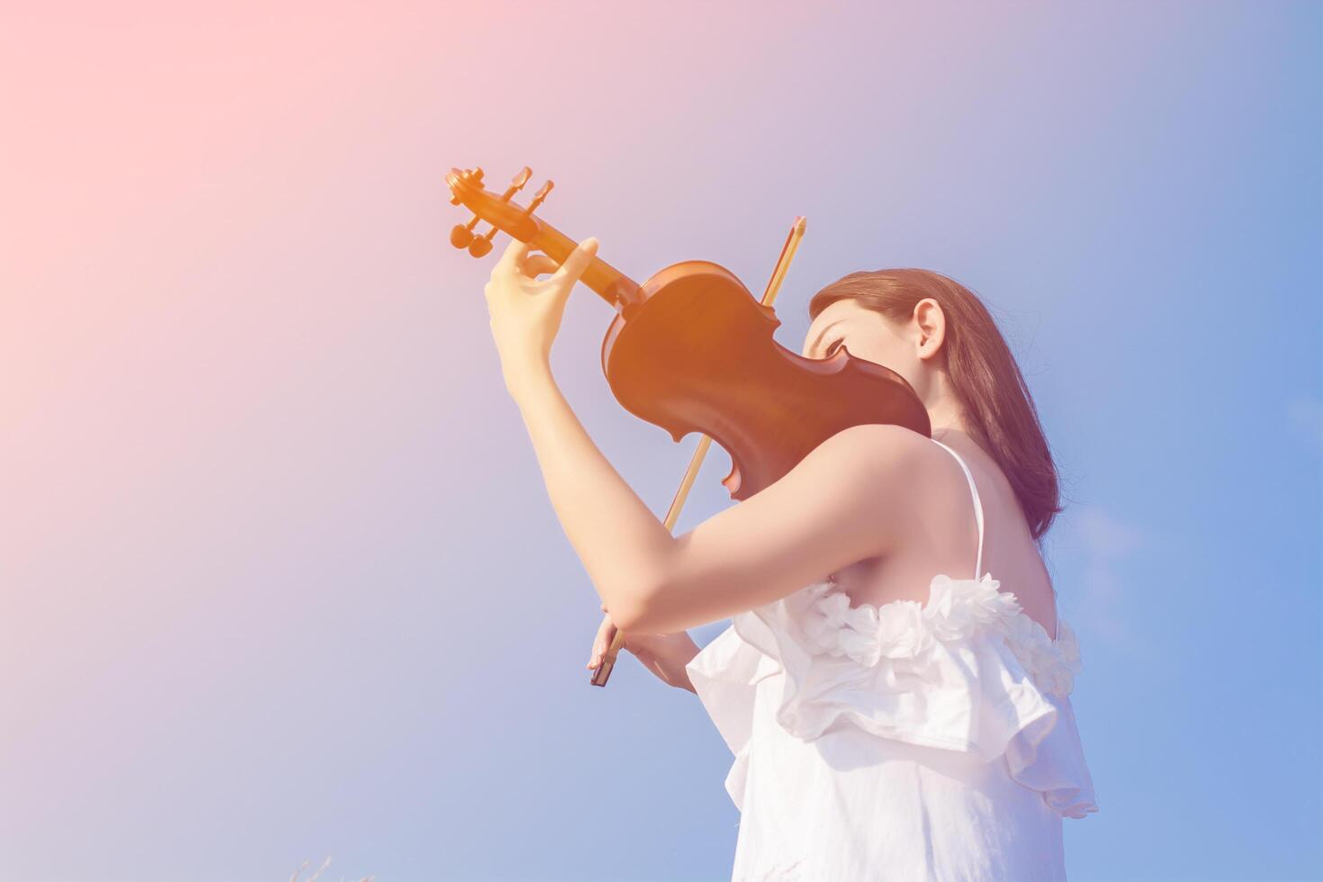 Beautiful women enjoy playing violin photo