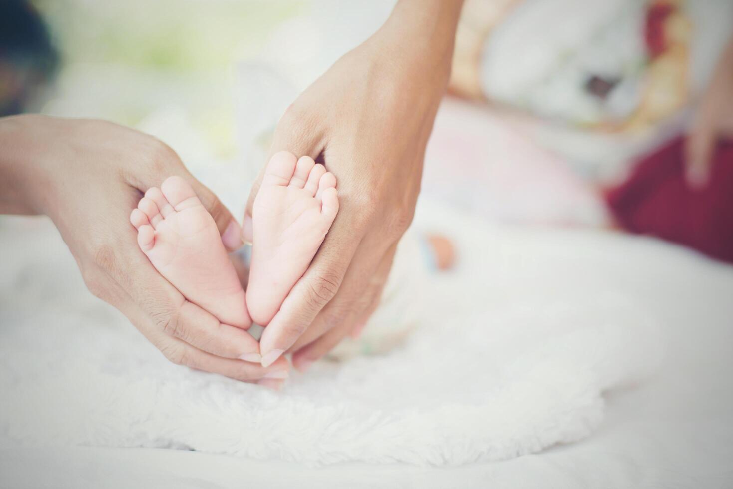 pies de bebé Newbron en manos de la madre. foto