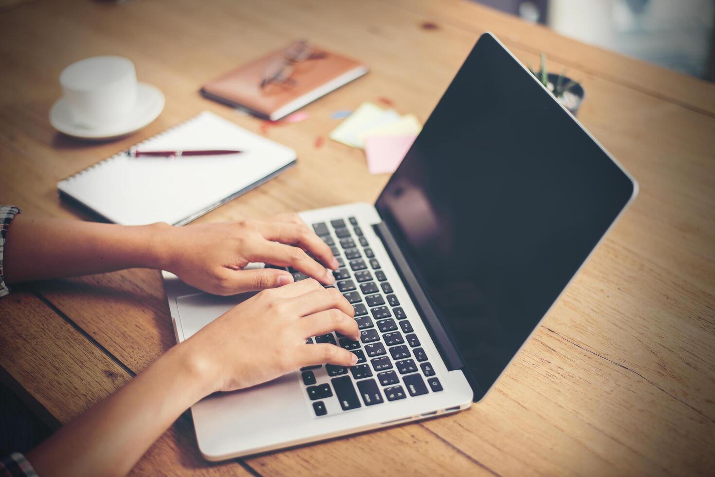 Close-up woman hands typing on laptop in office. photo