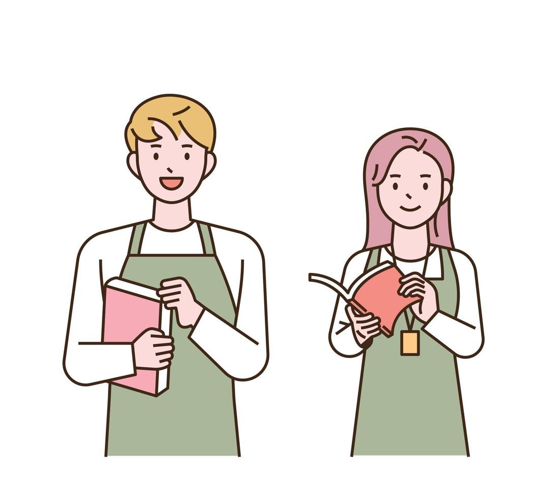 Bookstore employees wearing aprons are standing with smiles. vector