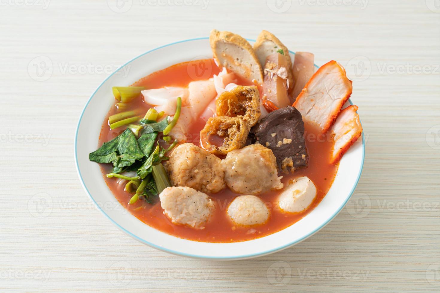 Noodles with meatballs in pink soup or Yen Ta Four Noodles in Asian style photo