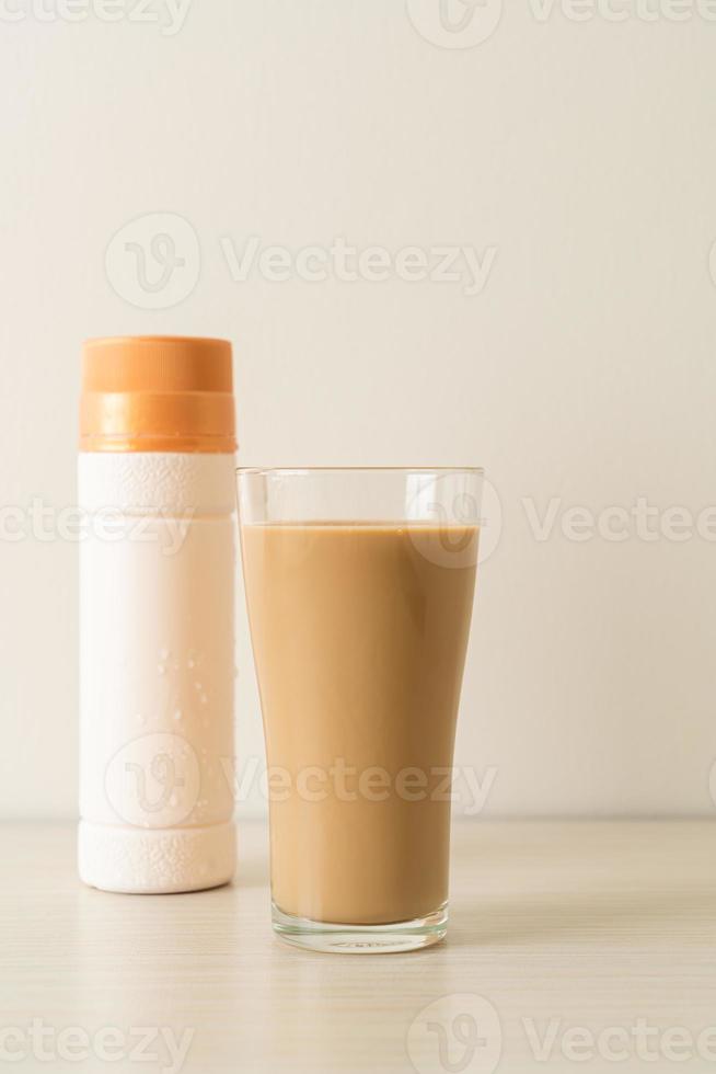 Coffee latte glass with ready to drink coffee bottles on the table photo