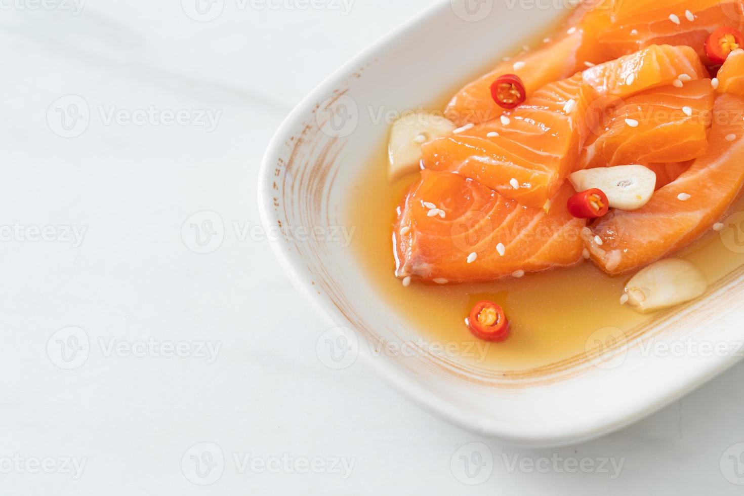 Fresh salmon raw marinated shoyu or salmon pickled soy sauce - Asian food style photo