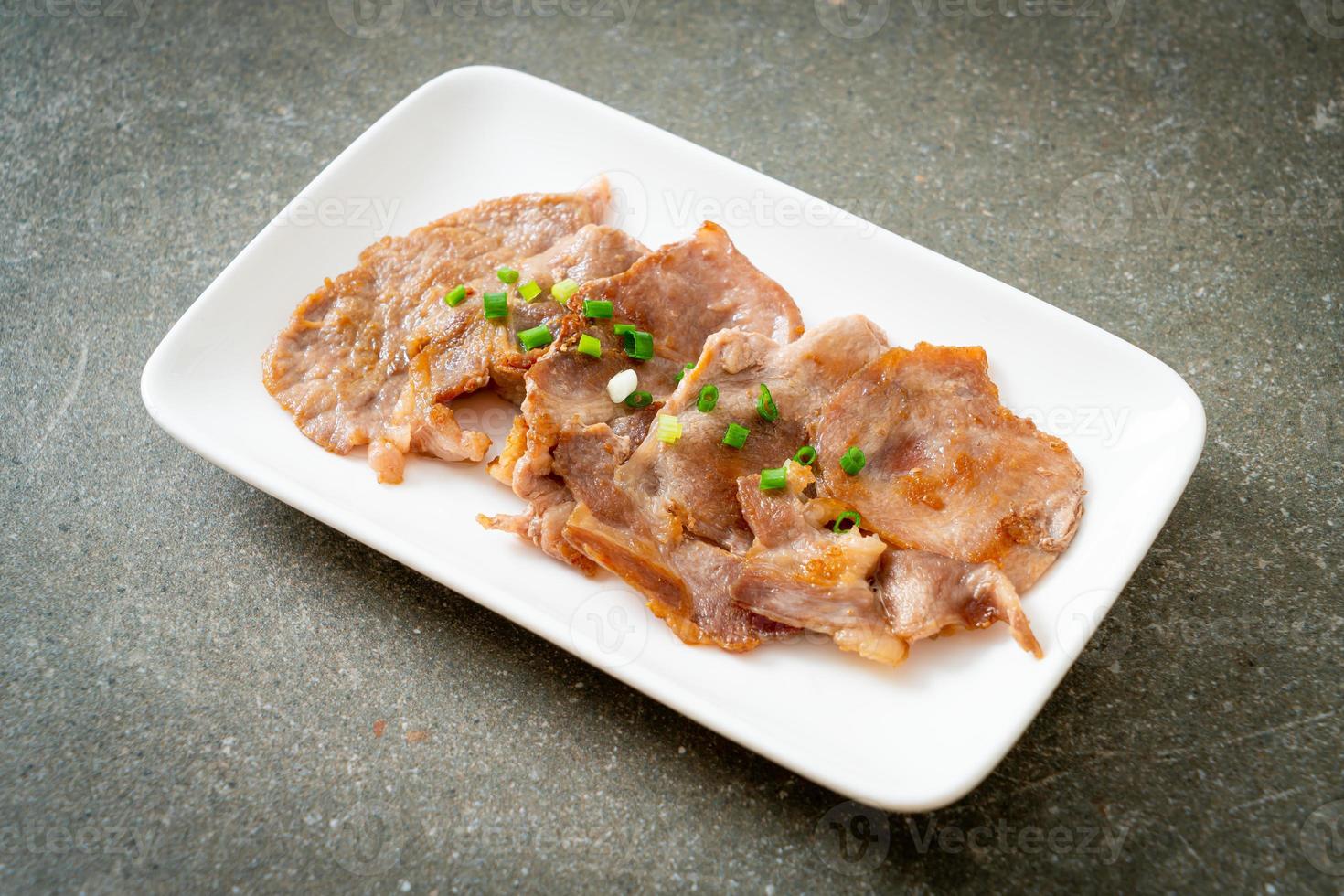 Grilled pork neck sliced on plate in Asian style photo