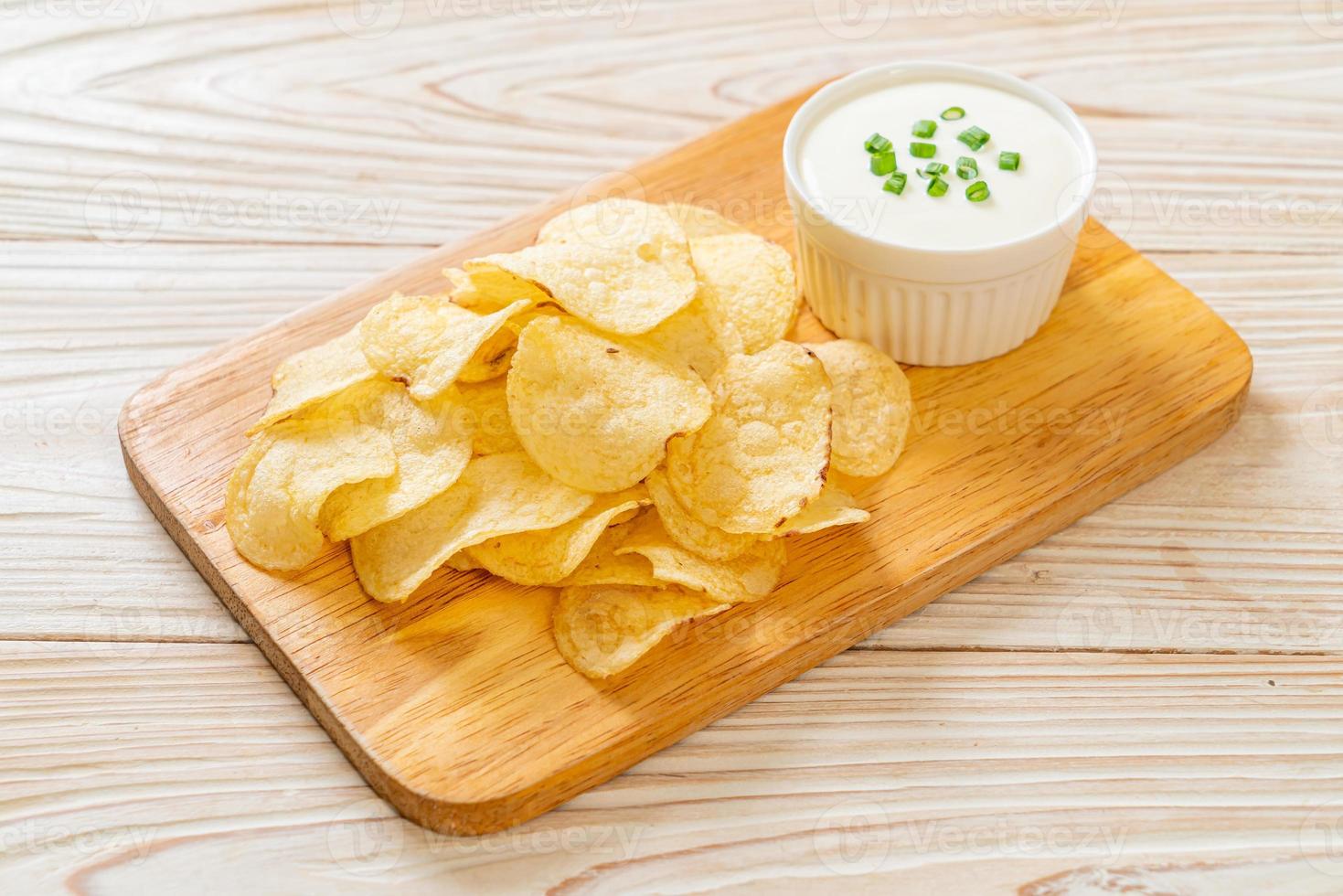 Potato chips with sour cream dipping sauce photo