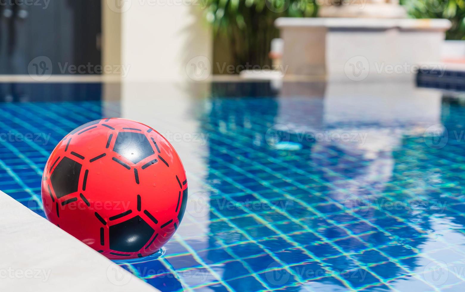 Inflatable colorful ball floating in a swimming pool photo