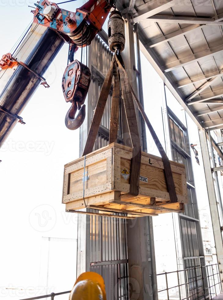 The crane carrying a box of radioactive holder to the floor of plant photo