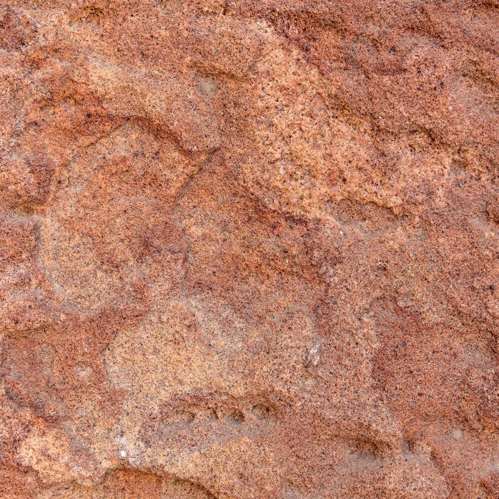 Fondo de textura de piedra rugosa roja. foto