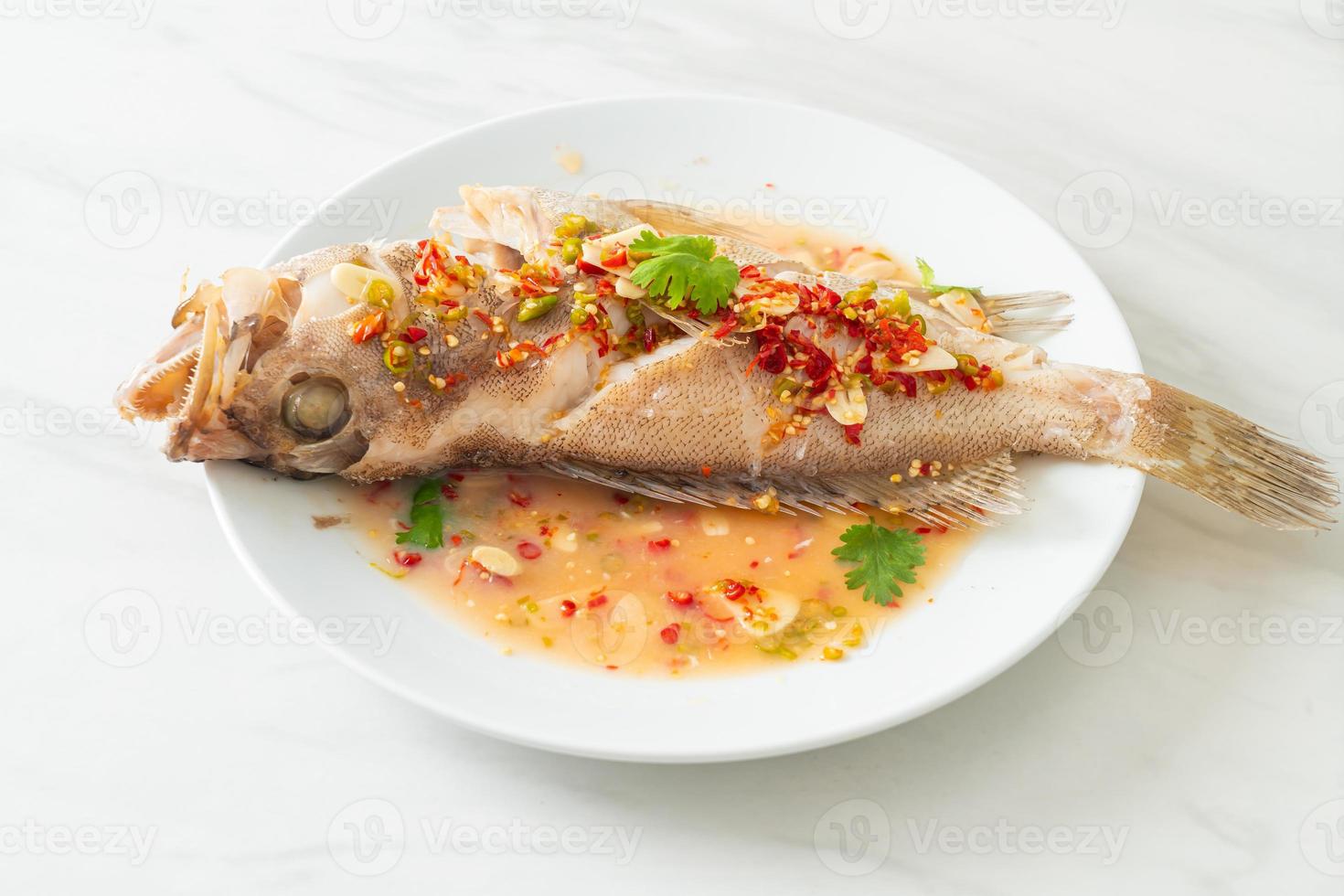 Steamed grouper fish with lime and chillies photo