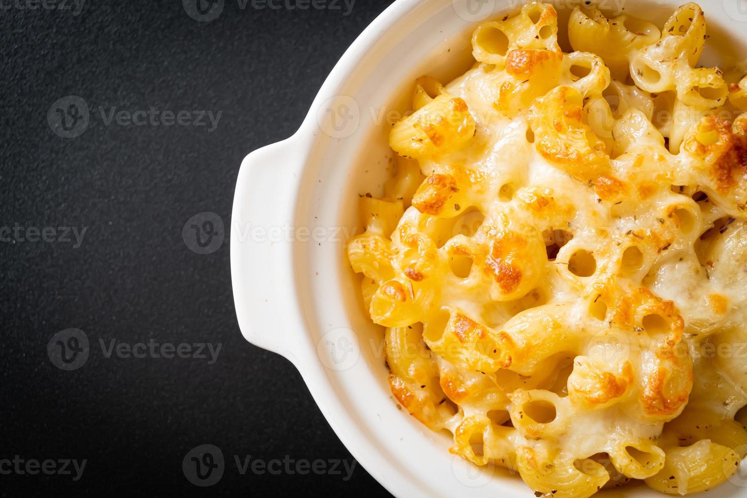 American mac and cheese, macaroni pasta in cheesy sauce photo