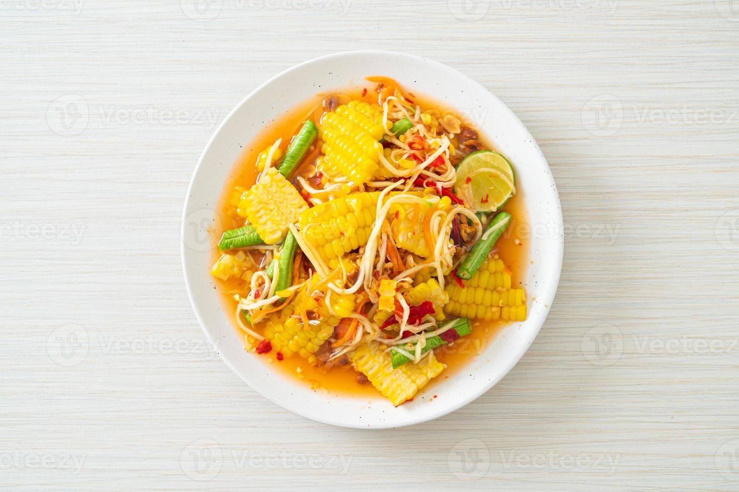 Som Tum - Thai spicy papaya salad with corn photo