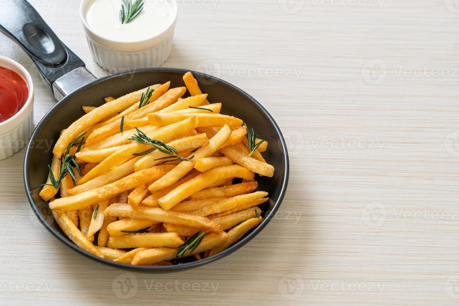 French fries with sour cream and ketchup photo