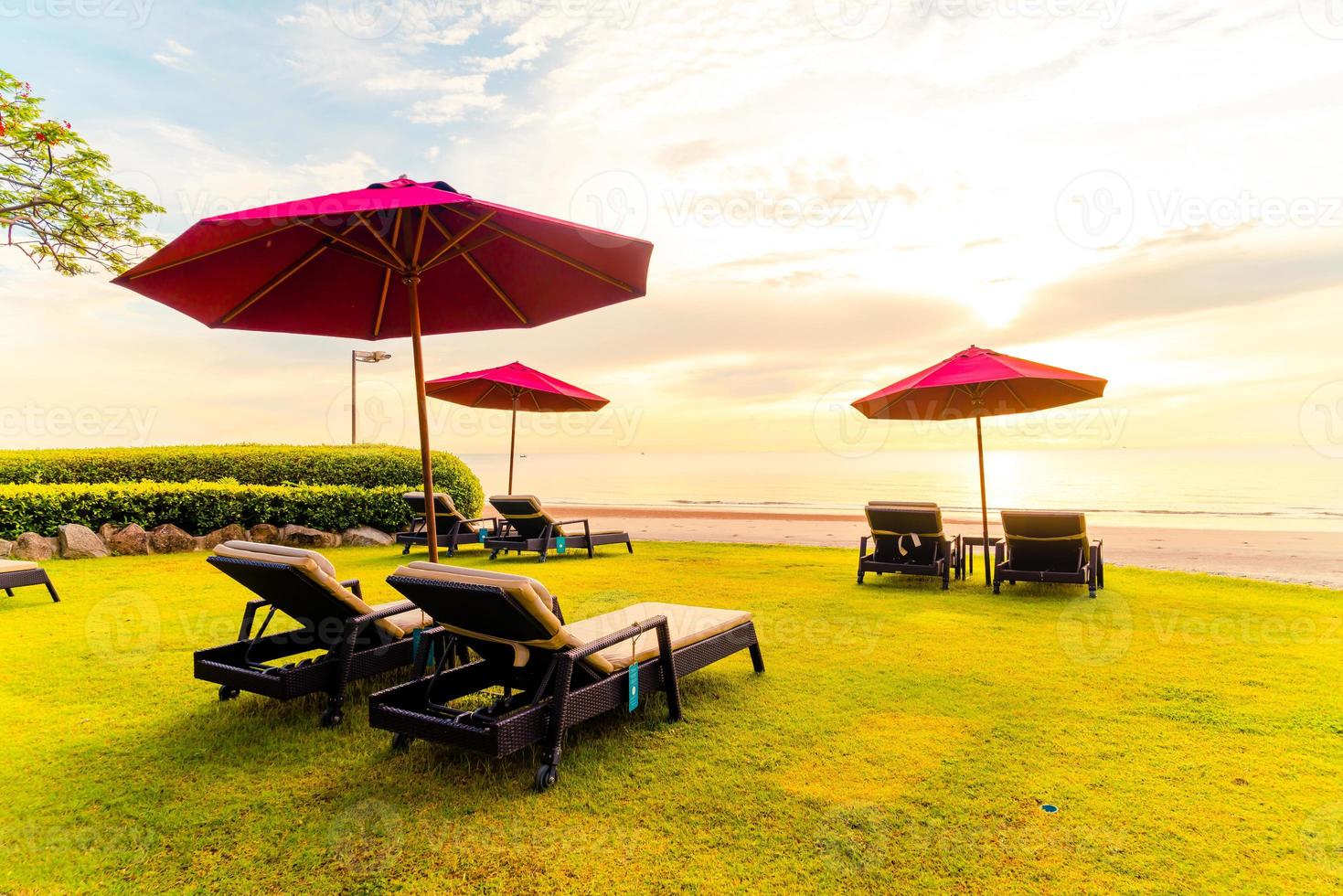 Umbrella with chair with sea beach background and sunrise in morning photo