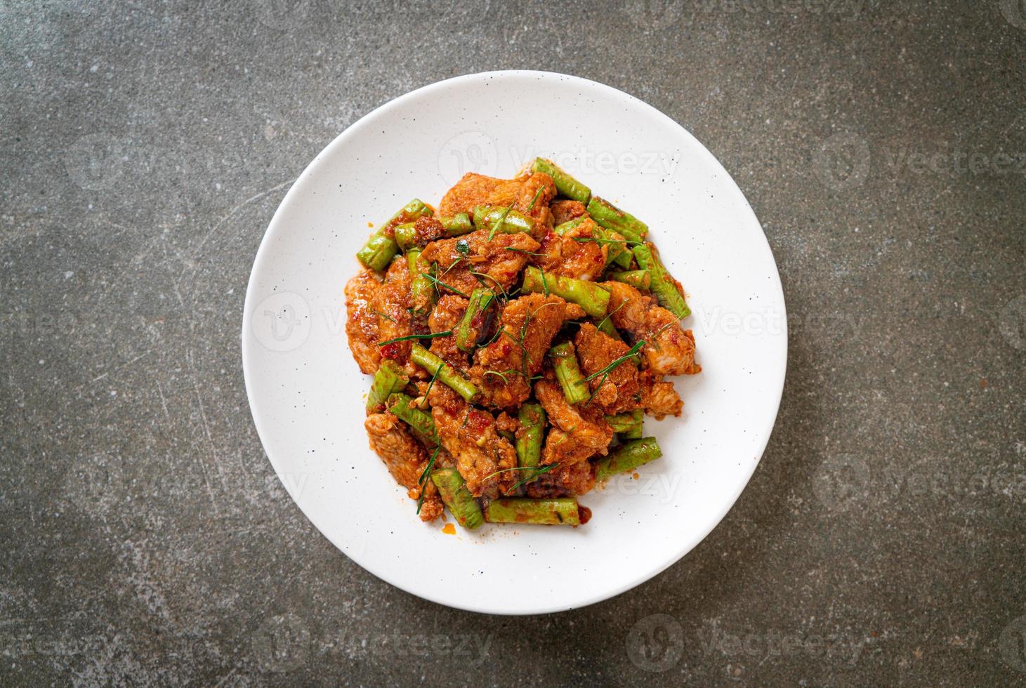 Stir fried pork and red curry paste with sting bean photo