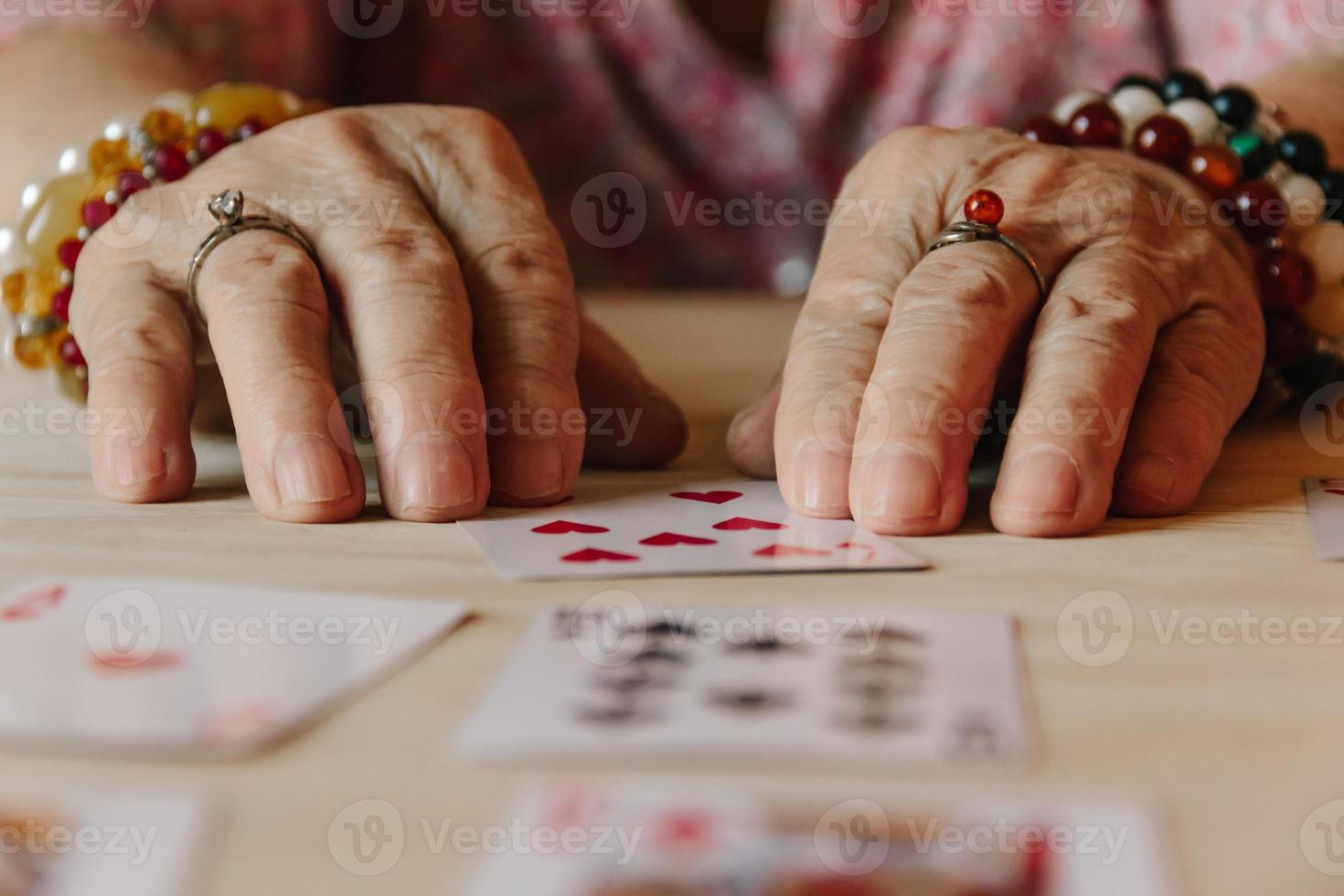 Guessing cards reading, grandma magic, fortune telling, women hands photo