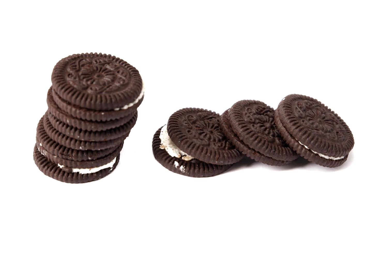 Tasty chocolate cookies with cream on white background photo