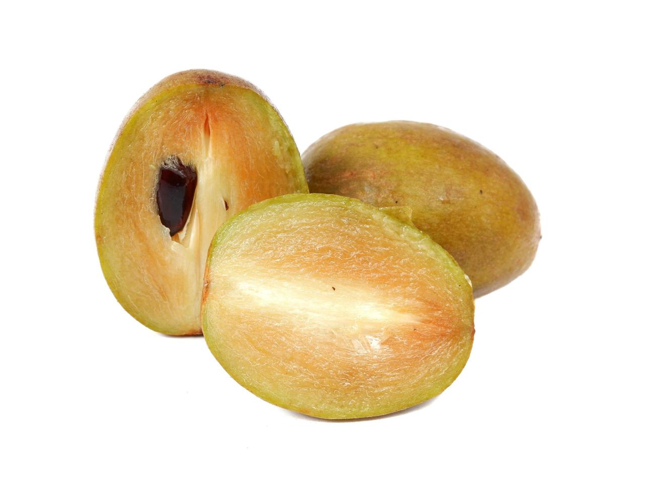 Fresh sapodilla plum with cut on white photo