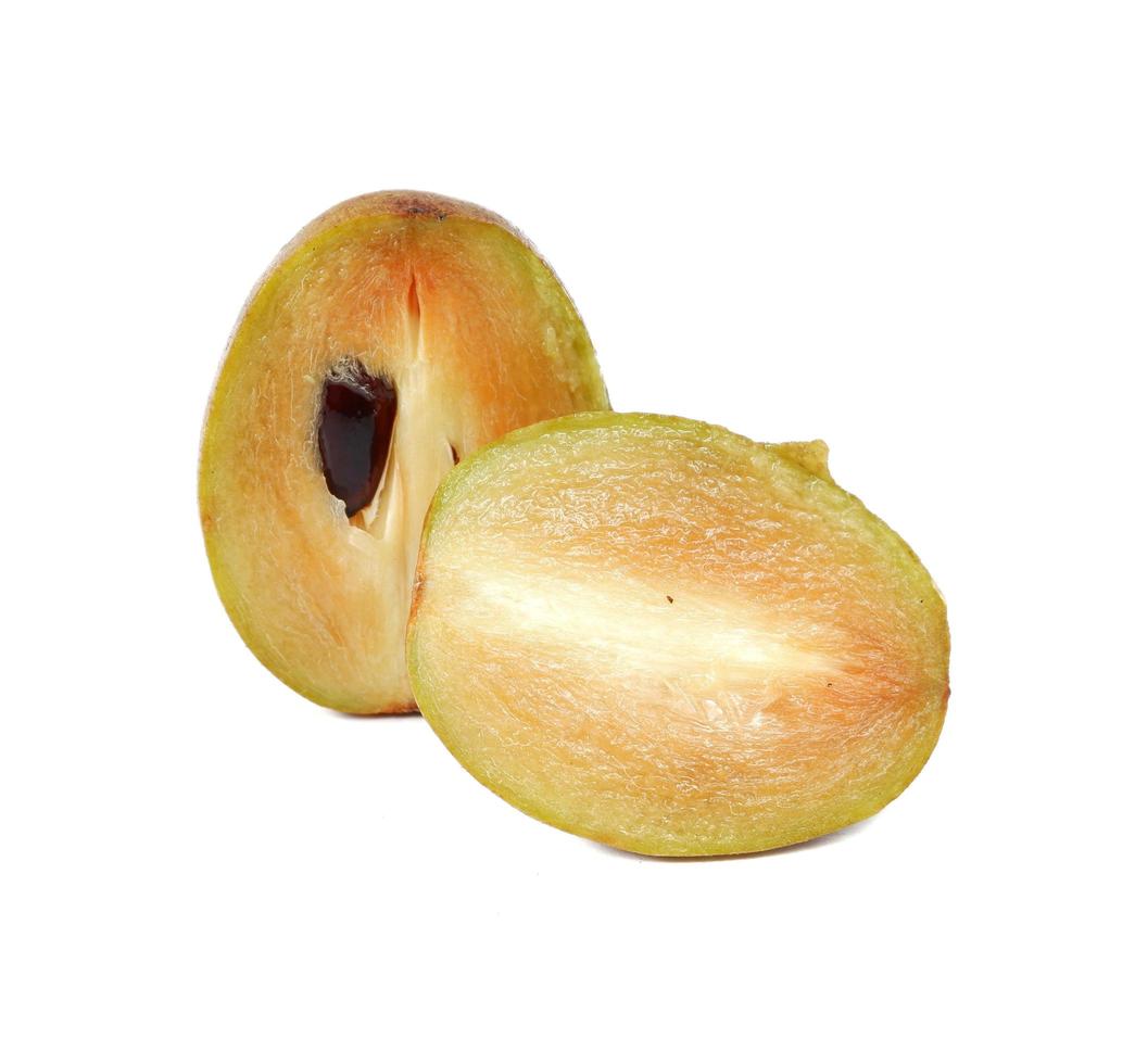 Fresh sapodilla plum with cut on white photo