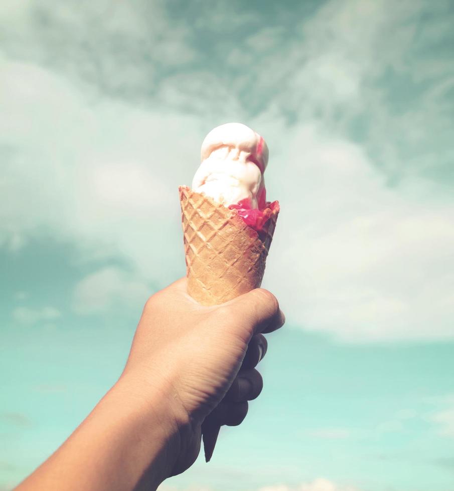 Girl hand holding ice cream photo