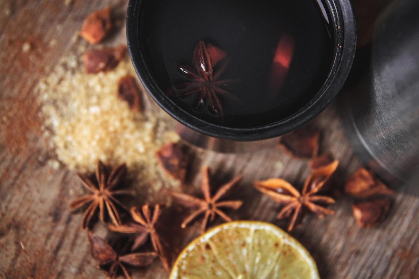 Freshly homemade mulled wine in a bowl on a wooden rusric board photo