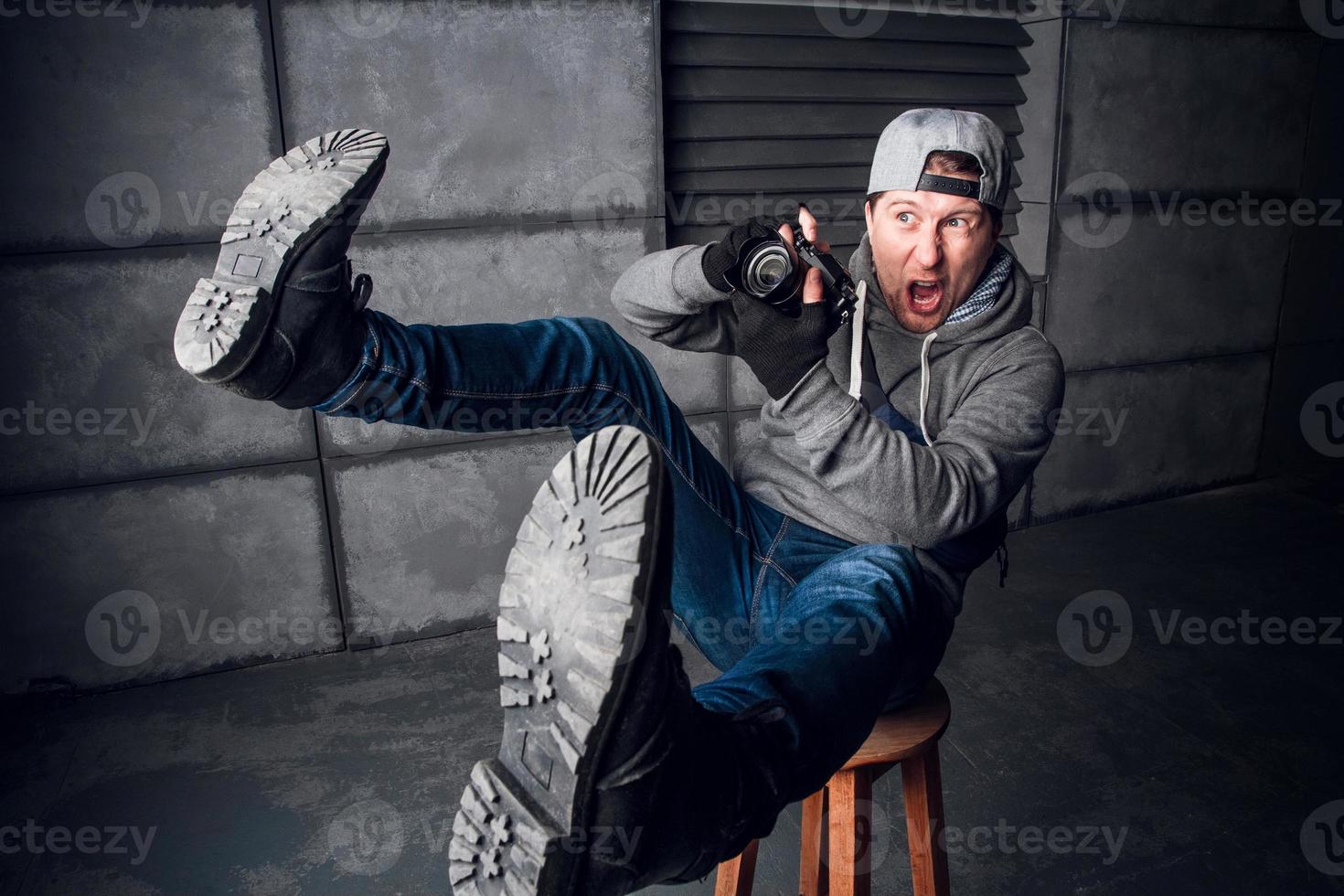 Man is a photographer with camera. Funny Face. Dark gray background photo