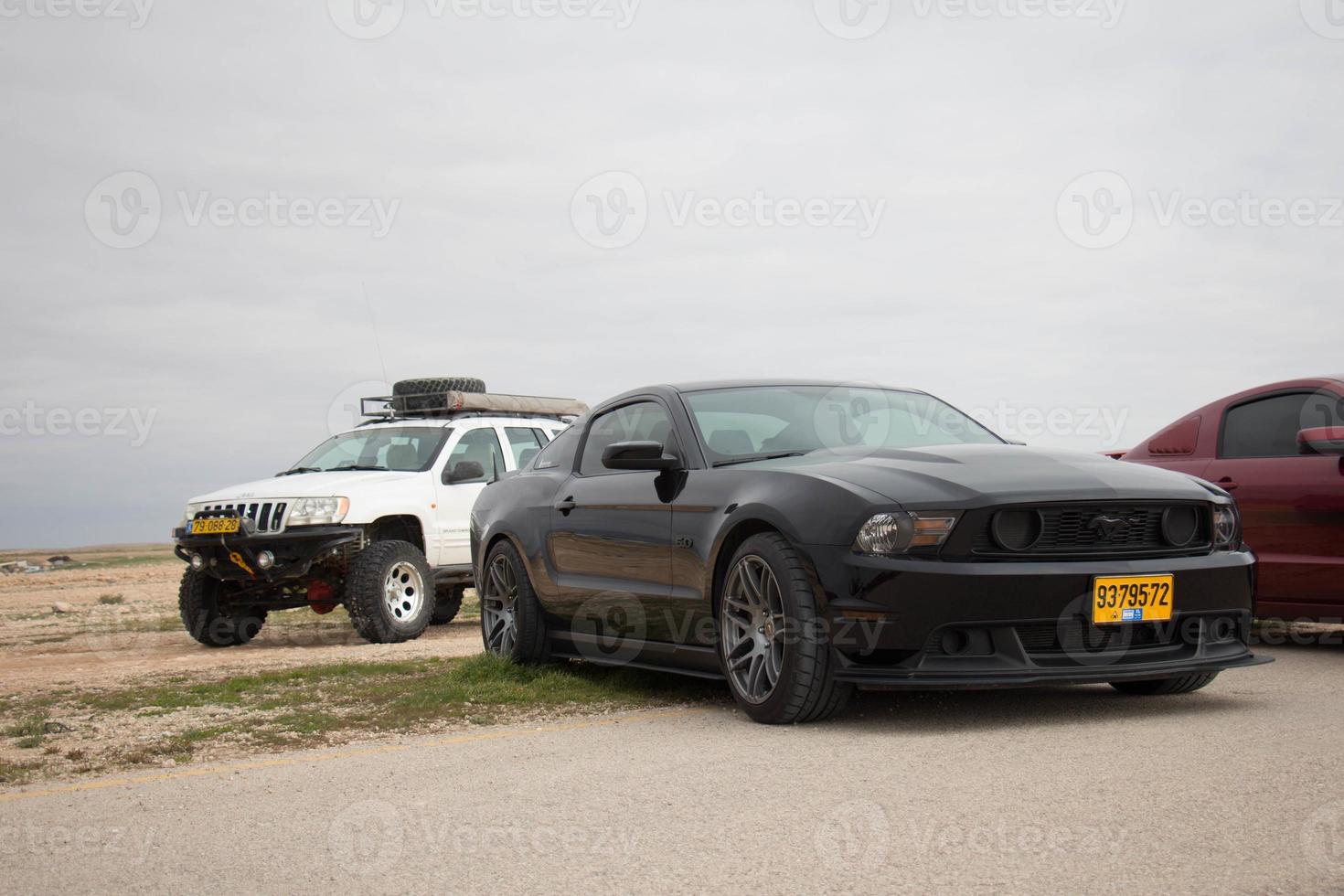 Cars on the race track and on the roads of the desert photo