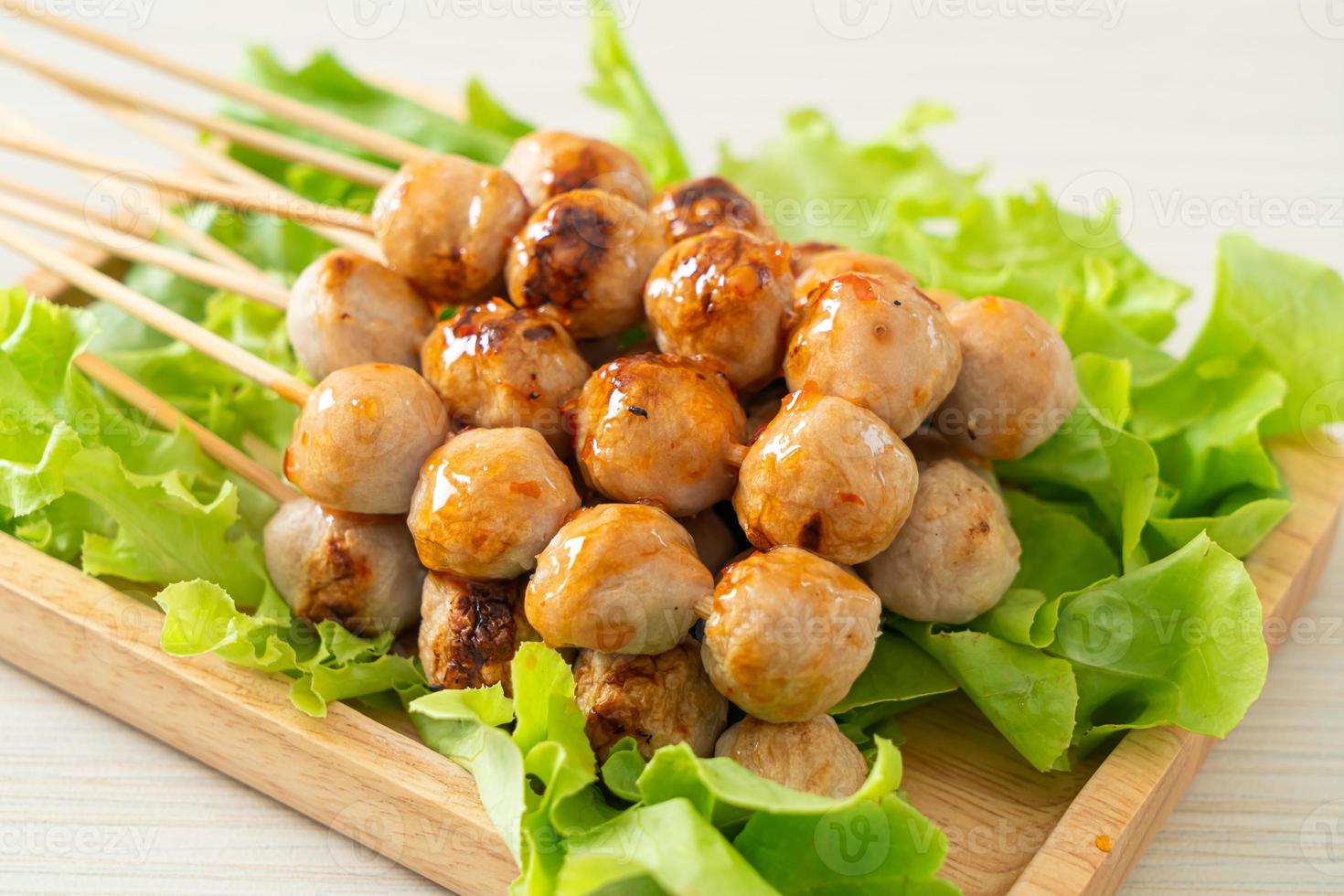 Grilled meatballs skewer with spicy dipping sauce photo