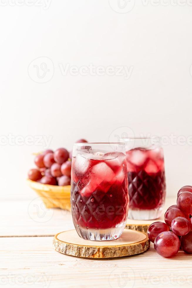 Fresh grape juice on wood background photo