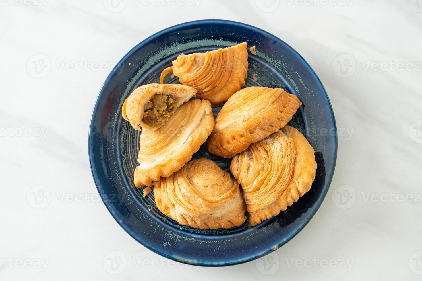 Curry puff pastry stuffed chicken on plate photo