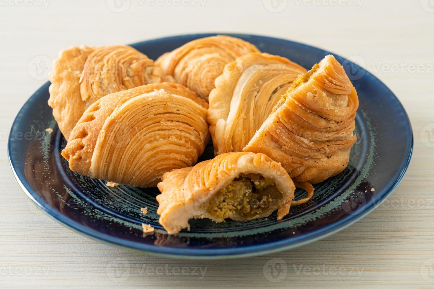 Curry puff pastry stuffed chicken on plate photo