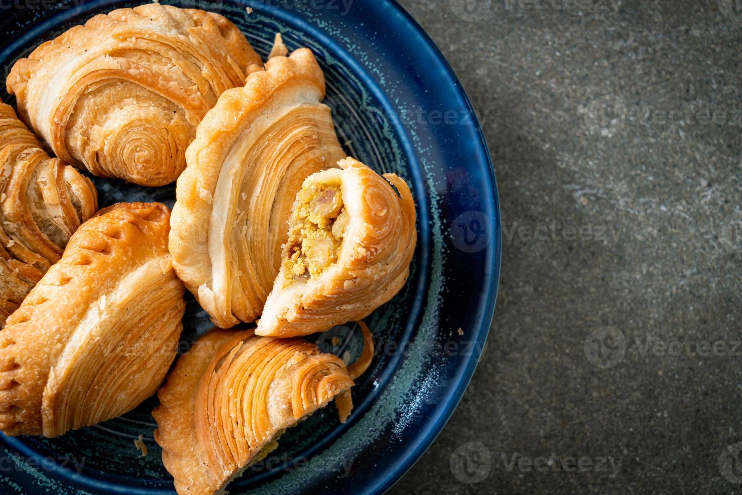 Curry puff pastry stuffed chicken on plate photo