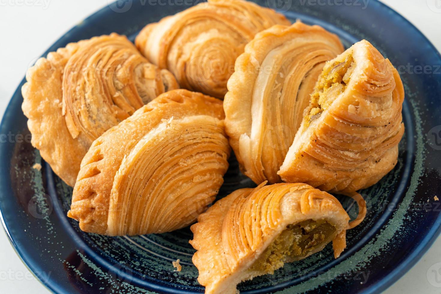 Curry puff pastry stuffed chicken on plate photo