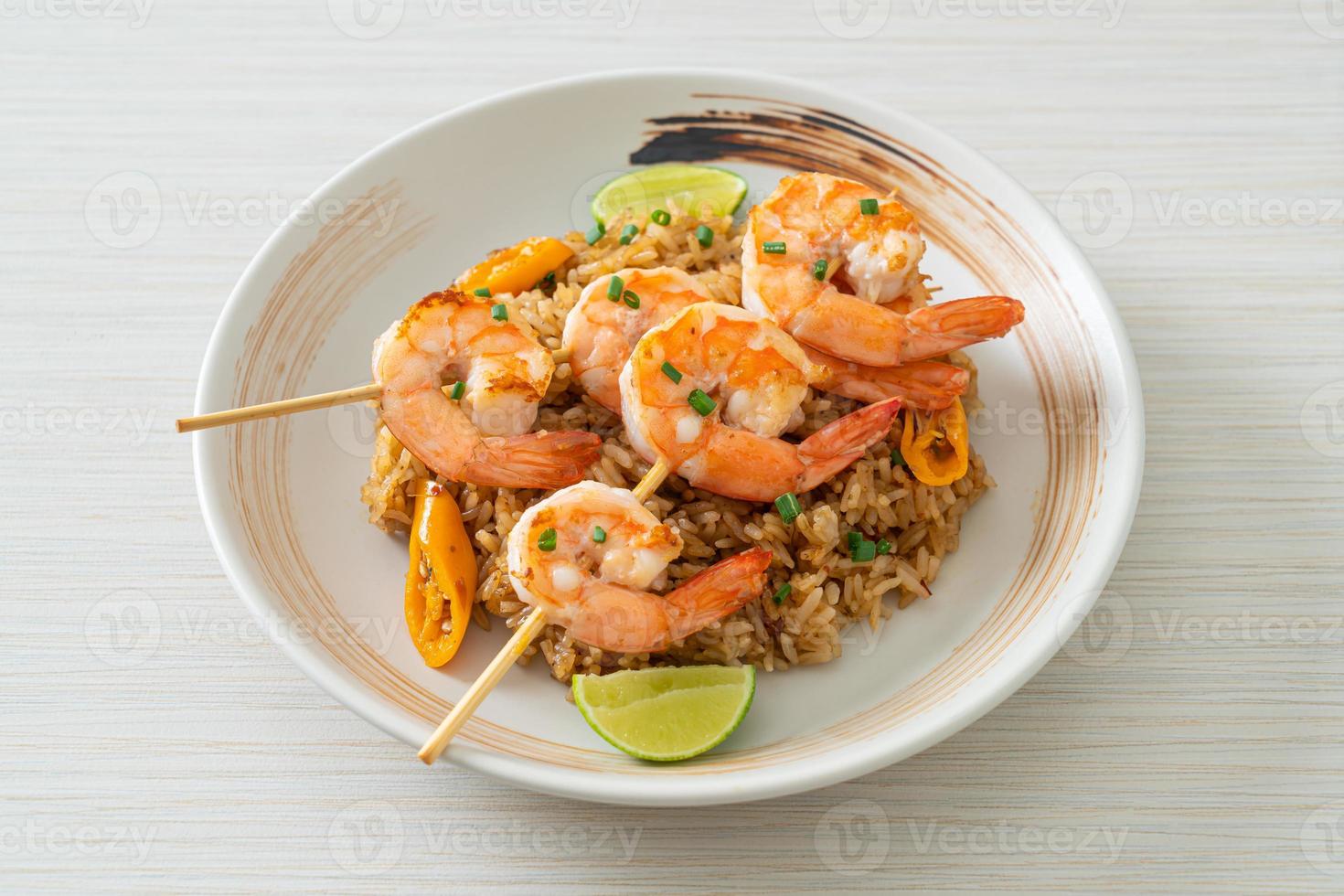 Fried rice with shrimps or prawns skewers photo