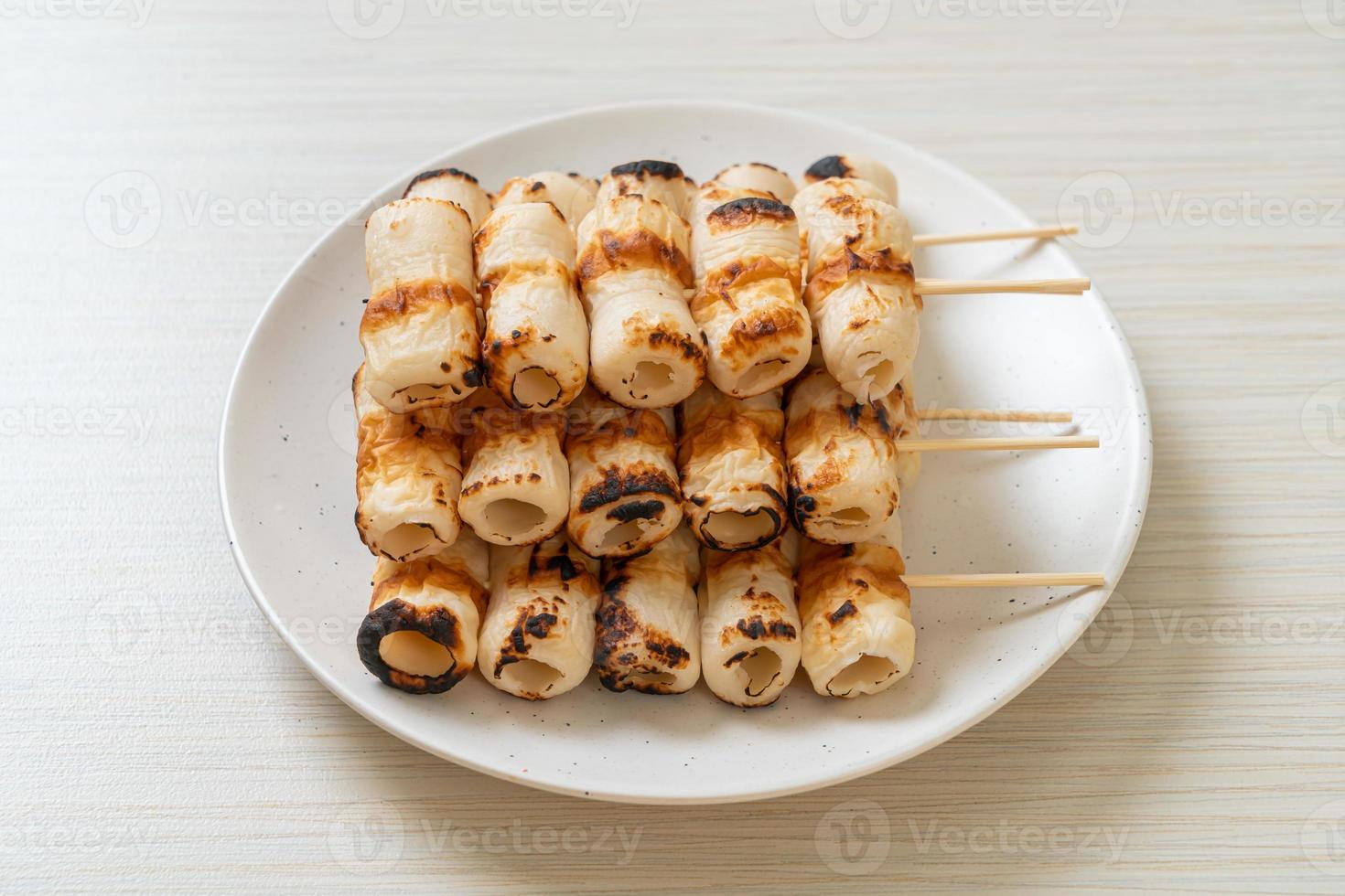 Grilled tube-shaped fish paste cake or tube squid skewer on plate photo