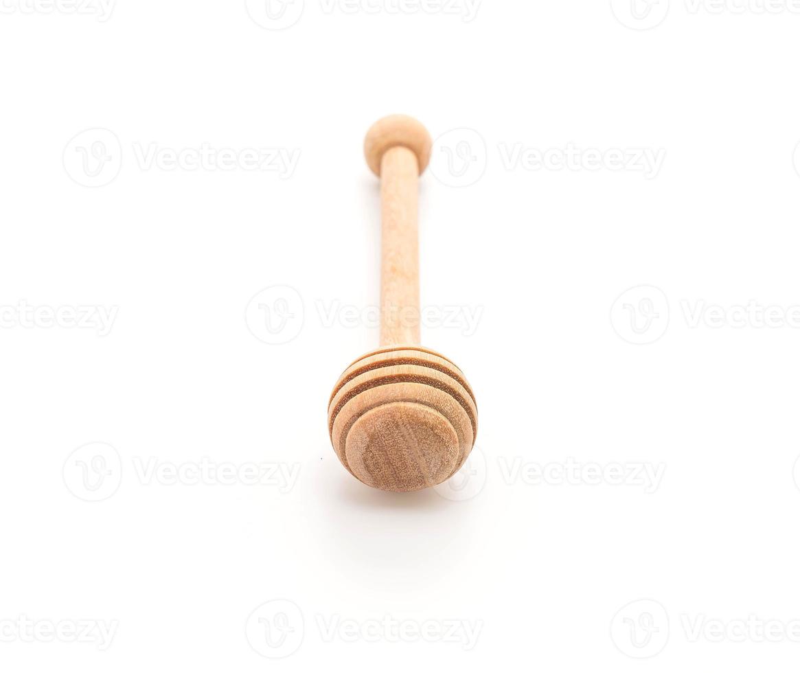 Wooden honey stick on white background photo